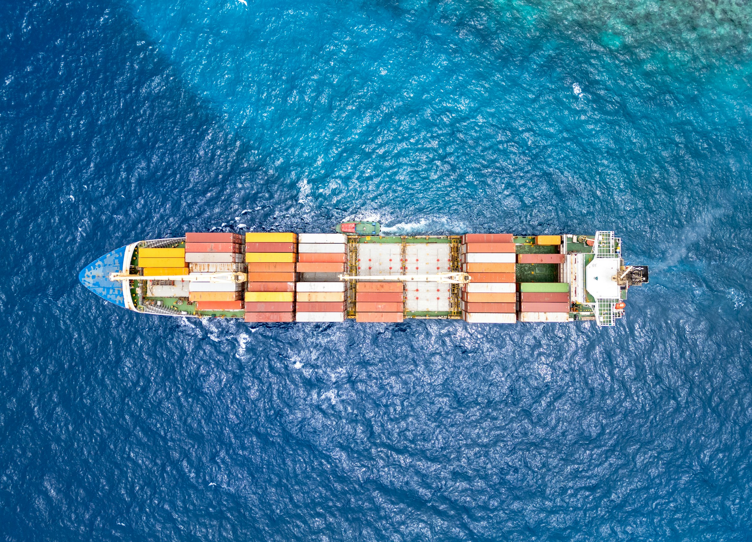 Aerial view of a container ship crossing open water